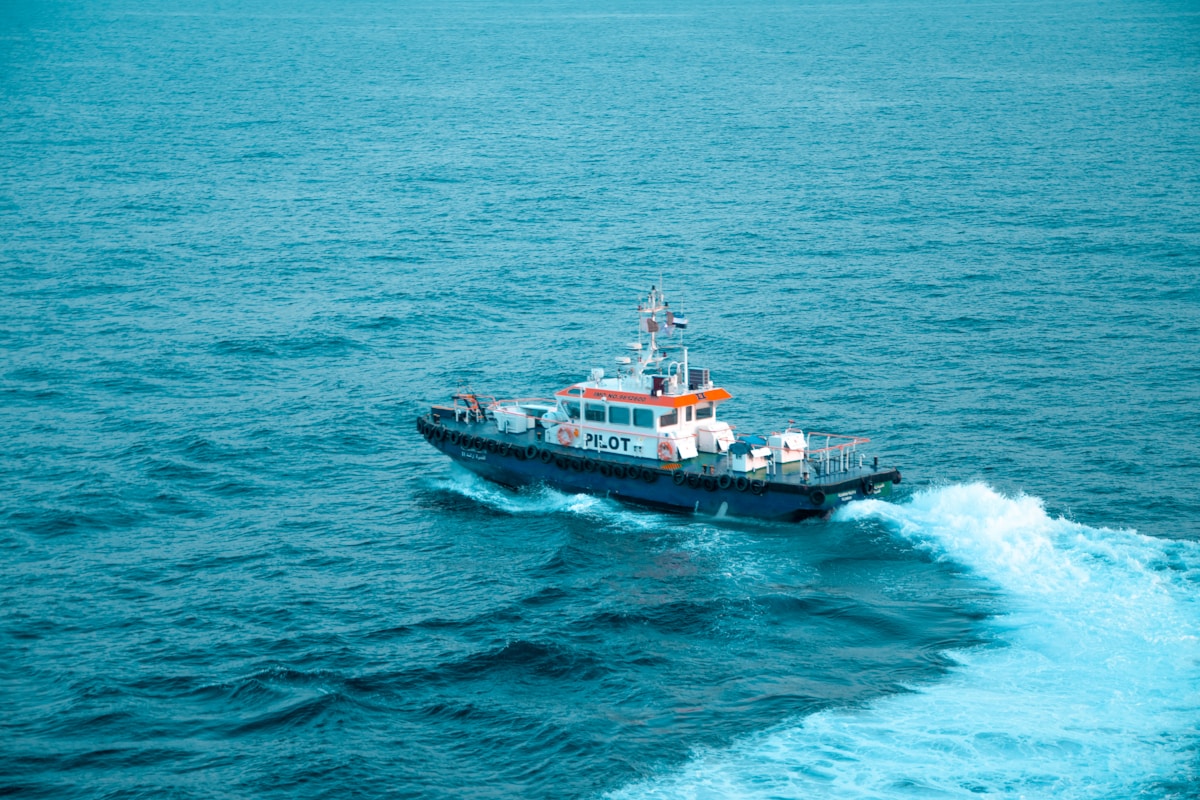 Modern ferry sailing across calm waters with passengers on deck